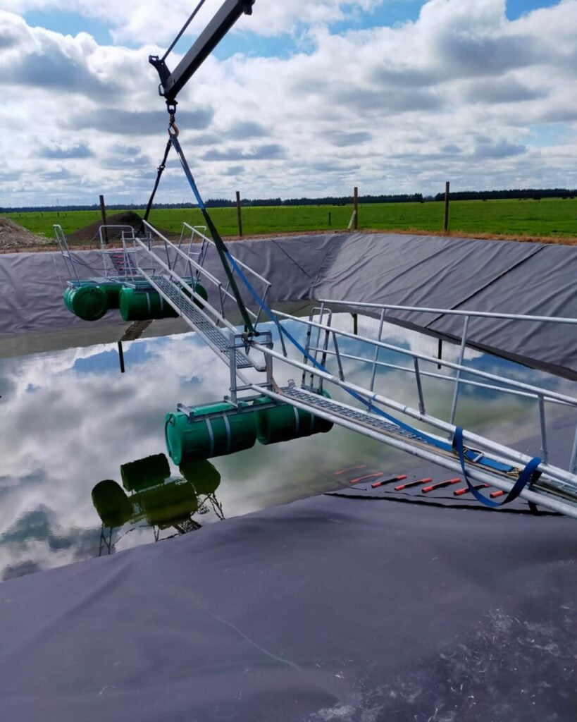 Plucks effluent stirrer walkway and float assembly being craned into a lined effluent pond in Canterbury