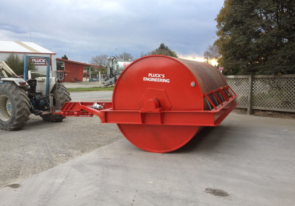 Plucks cover post Plucks spring-loaded drawbar fitted to a heavy land roller, hitched to a tractor at Plucks Engineering in Rakaia